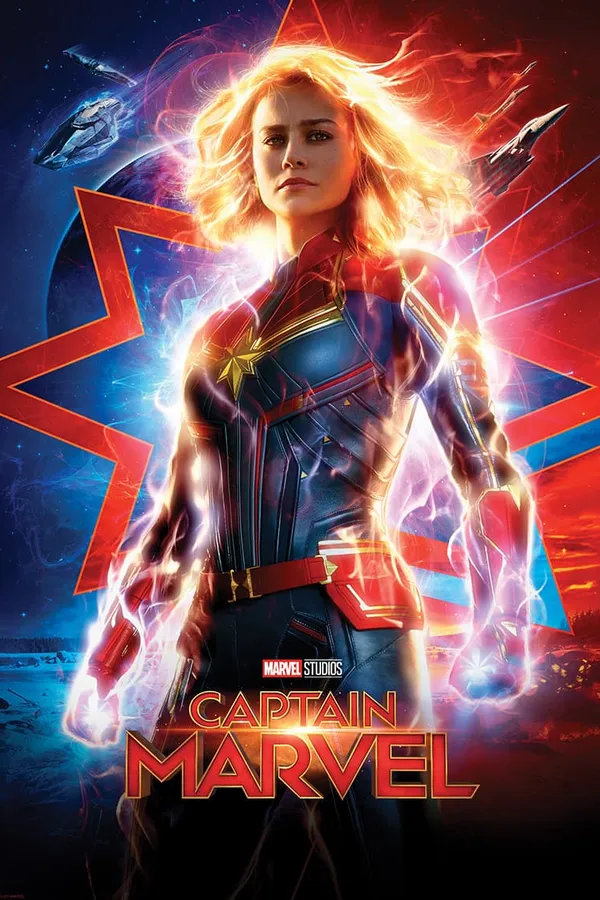 Poster resmi Captain Marvel (2019): Carol Danvers berkostum merah biru dengan tubuh berpendar energi di depan lambang bintang.