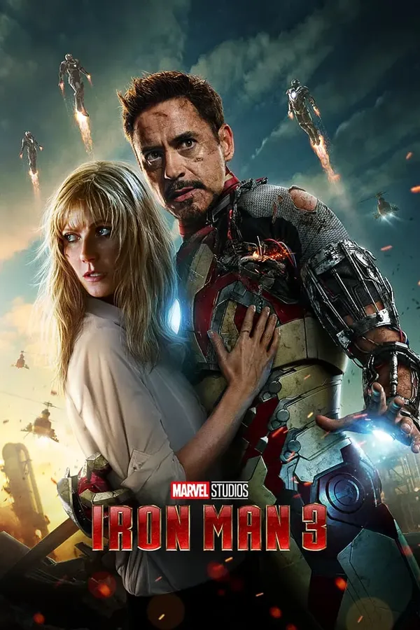 Poster resmi Iron Man 3 (2013): Tony Stark dengan baju zirah Iron Man yang rusak merangkul Pepper Potts, sementara beberapa armor Iron Man terbang di langit berawan di belakang mereka.