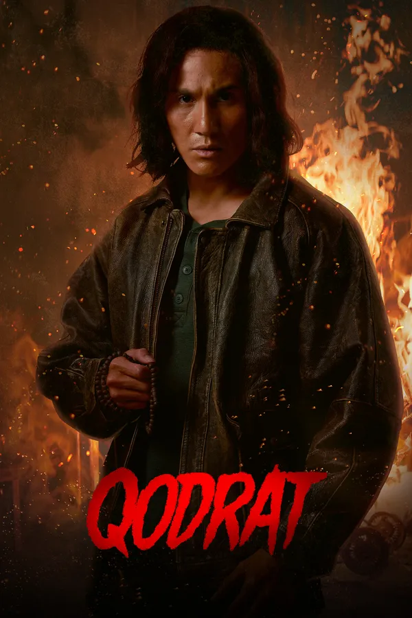 Poster resmi Qodrat (2022): Vino G. Bastian sebagai Ustaz Qodrat berjaket kulit memegang tasbih dengan latar kobaran api